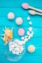 Sea Ã¢â¬â¹Ã¢â¬â¹salt in a glass white stones and Shell for spa and relaxation on a blue background Royalty Free Stock Photo